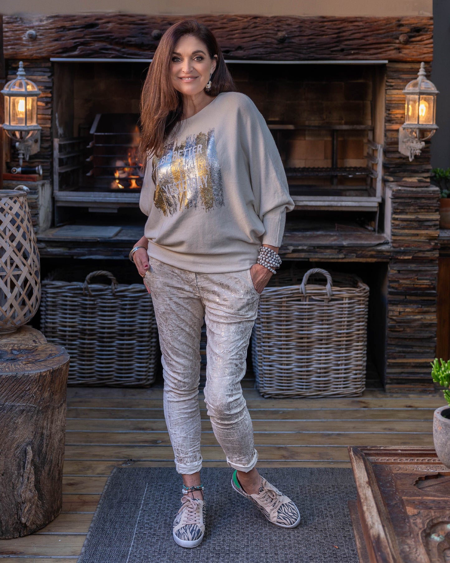 A new take on our ever so popular knits! The batwing cut design offers a relaxed fit through the arms and shoulders. The knit transitions into fitted hips, creating a flattering shape that complements the batwing sleeves. The scoop neck design beautifully frames your face, adding a touch of elegance to the knit. Foil print catches the light beautifully, making this knit perfect for both day and evening wear