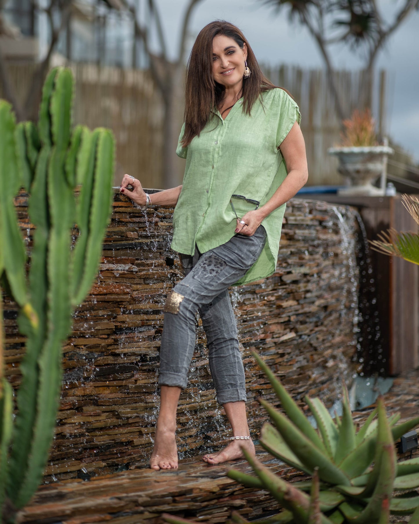 This sleeveless top embraces the breathability and natural texture of linen, ensuring you stay cool and comfortable all day long. The wide cut design provides a relaxed and flowy silhouette. With a button-up front and a stylish collar, this top offers a touch of modern elegance. You can also add a front knot for a more playful look