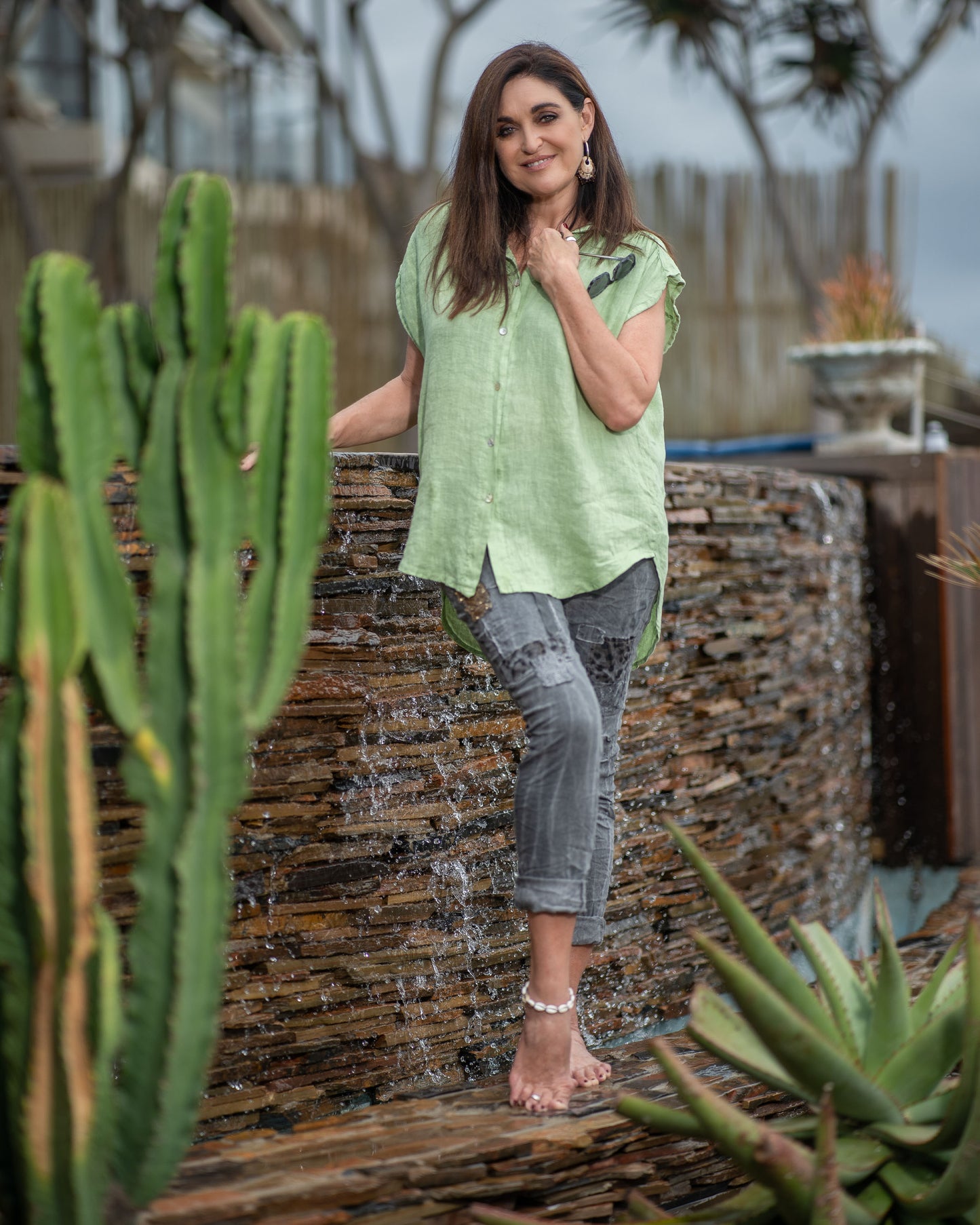 This sleeveless top embraces the breathability and natural texture of linen, ensuring you stay cool and comfortable all day long. The wide cut design provides a relaxed and flowy silhouette. With a button-up front and a stylish collar, this top offers a touch of modern elegance. You can also add a front knot for a more playful look