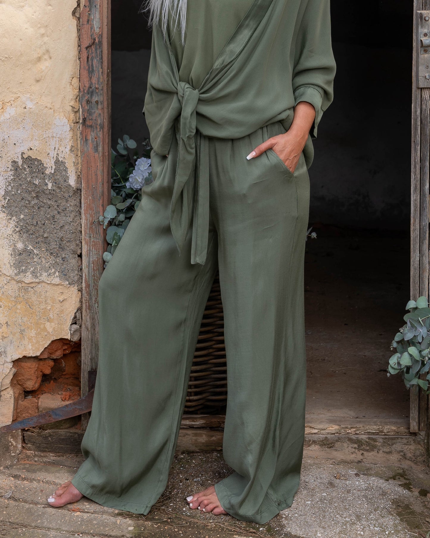 These pants offer a super soft and cool feel against your skin, perfect for warm days or lounging in style. The wide-leg design ensures a flattering silhouette, while the elasticated waistband provides a comfortable fit that moves with you. A decorative drawstring bow adds a touch of charm and versatility, making these pants as stylish as they are practical. Whether you're dressing up for an evening out or keeping it casual, these pants are your go-to for easy elegance