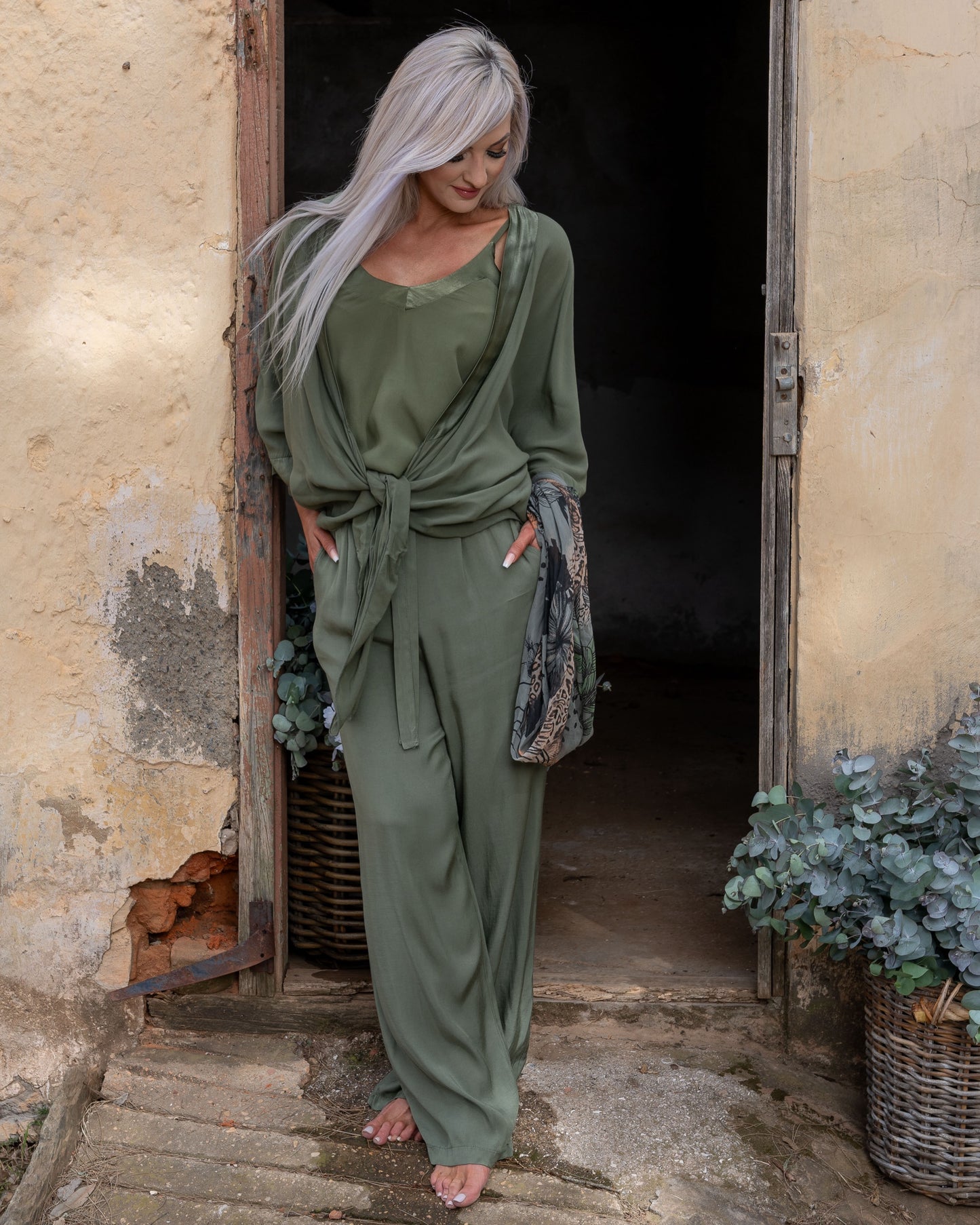These pants offer a super soft and cool feel against your skin, perfect for warm days or lounging in style. The wide-leg design ensures a flattering silhouette, while the elasticated waistband provides a comfortable fit that moves with you. A decorative drawstring bow adds a touch of charm and versatility, making these pants as stylish as they are practical. Whether you're dressing up for an evening out or keeping it casual, these pants are your go-to for easy elegance