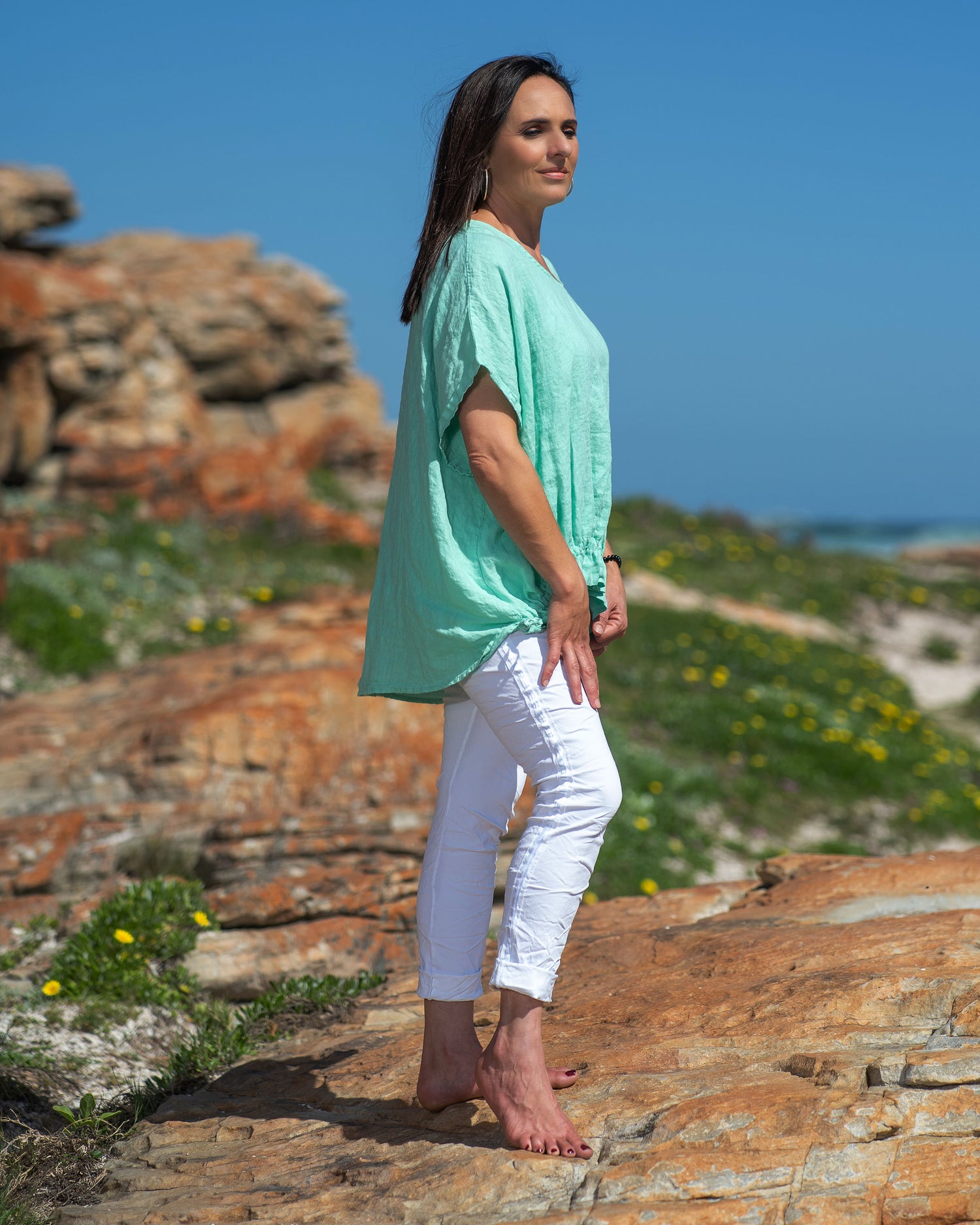 Step into the world of casual chic with this very comfortable, yet stylish linen top. What sets this top apart is its playful frill detailing, adding a touch of whimsy and femininity to your look. The natural, breathable linen fabric keeps you cool and fresh even on the warmest days, making it a must-have addition to your summer wardrobe