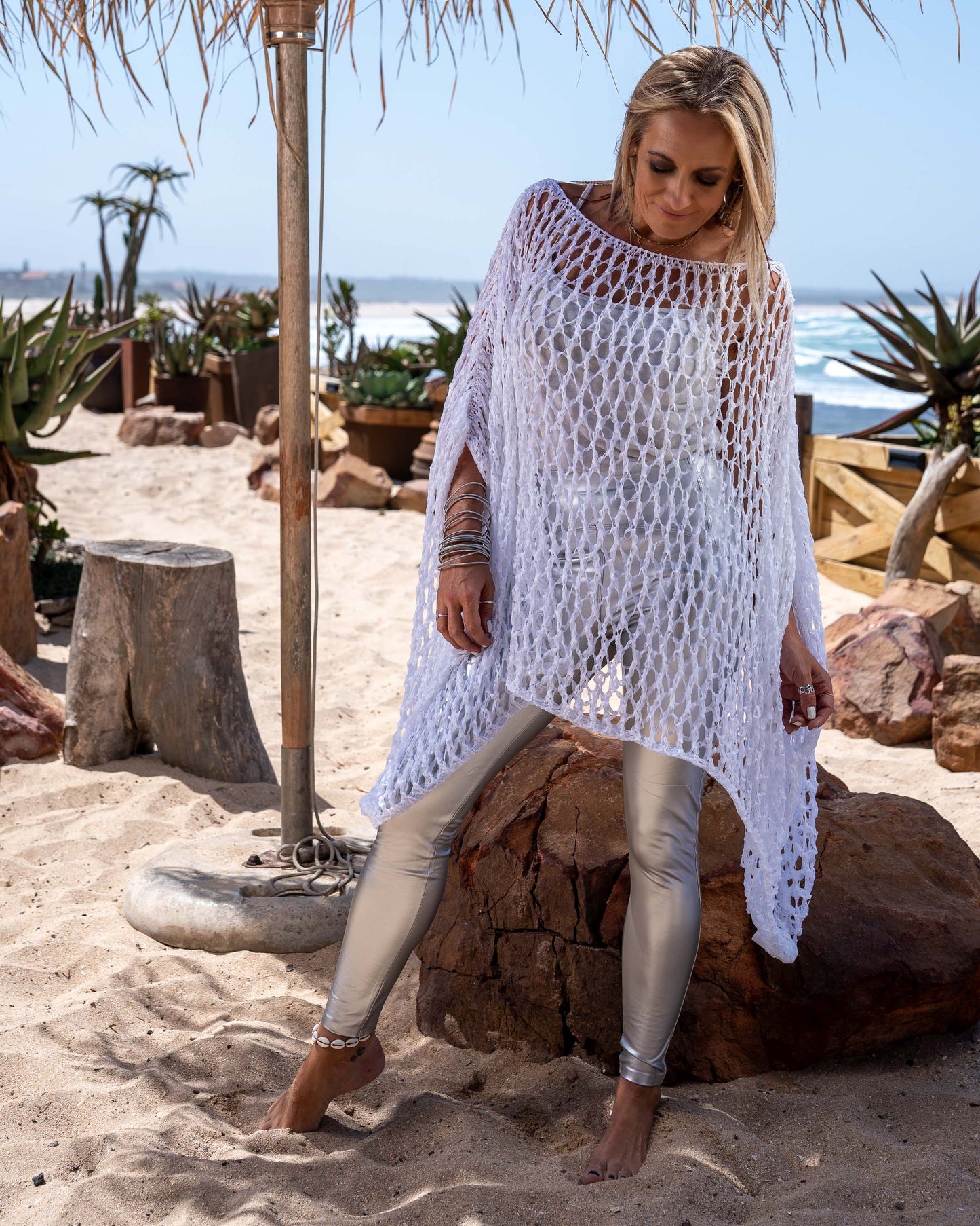 This poncho is designed to envelop you in a cocoon of softness and elegance.Indulge in the luxurious feel of its premium, loosely knitted fabric that drapes effortlessly over your shoulders. The ultra-soft material gently caresses your skin, providing unparalleled comfort. The loose-knit construction adds a touch of airy sophistication, allowing for breathability