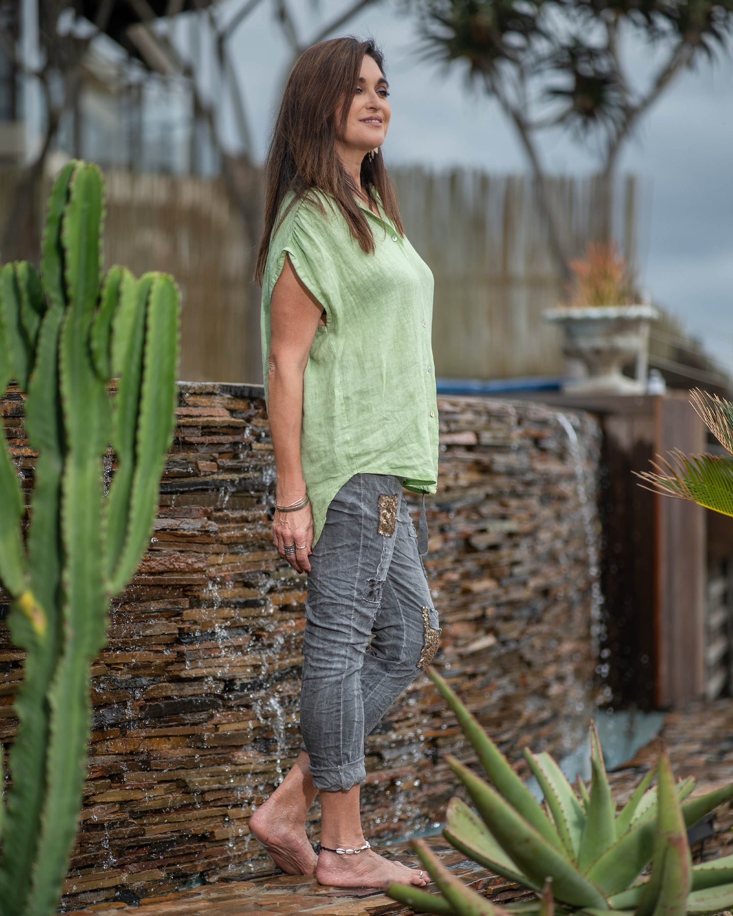 This sleeveless top embraces the breathability and natural texture of linen, ensuring you stay cool and comfortable all day long. The wide cut design provides a relaxed and flowy silhouette. With a button-up front and a stylish collar, this top offers a touch of modern elegance. You can also add a front knot for a more playful look