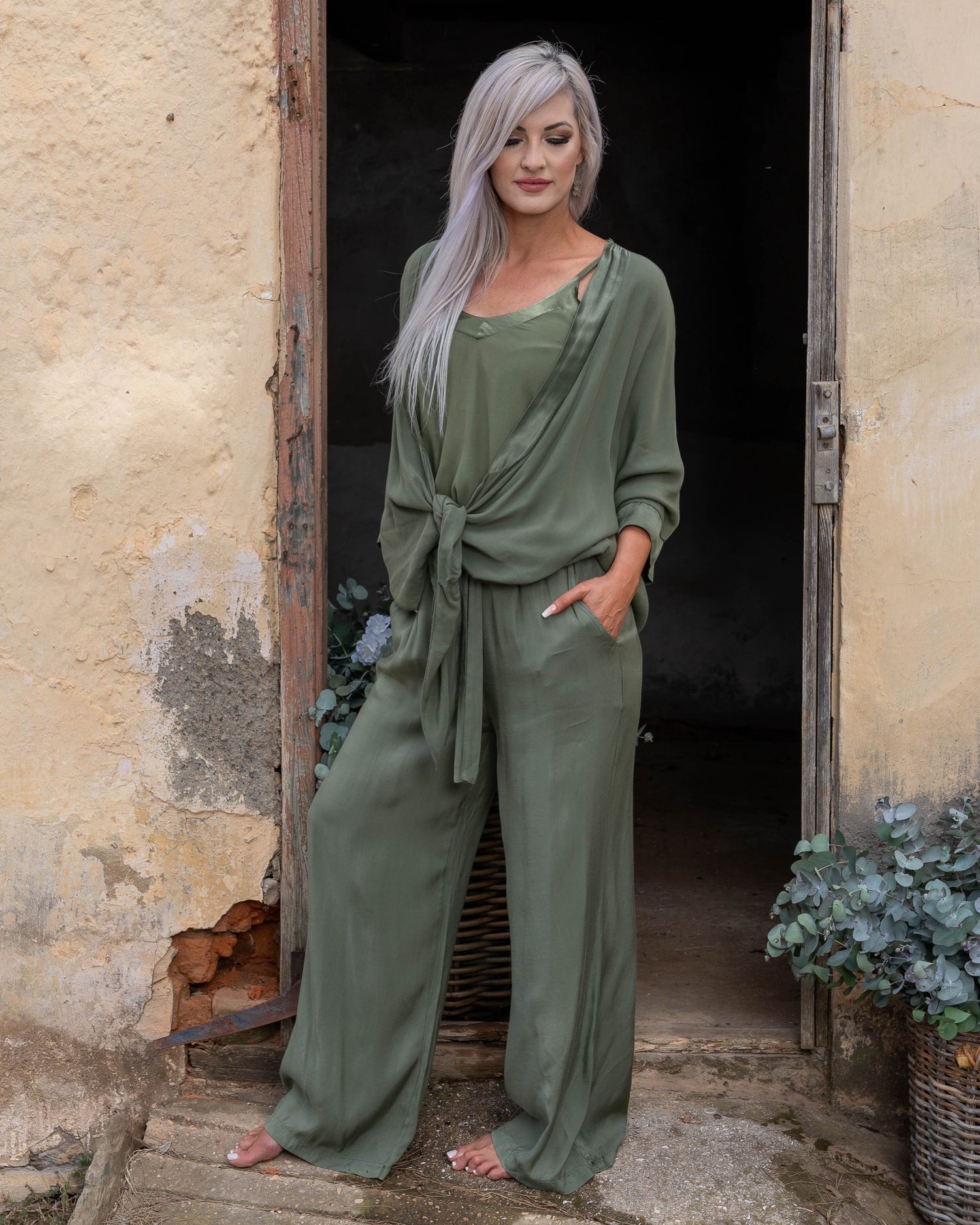 These pants offer a super soft and cool feel against your skin, perfect for warm days or lounging in style. The wide-leg design ensures a flattering silhouette, while the elasticated waistband provides a comfortable fit that moves with you. A decorative drawstring bow adds a touch of charm and versatility, making these pants as stylish as they are practical. Whether you're dressing up for an evening out or keeping it casual, these pants are your go-to for easy elegance