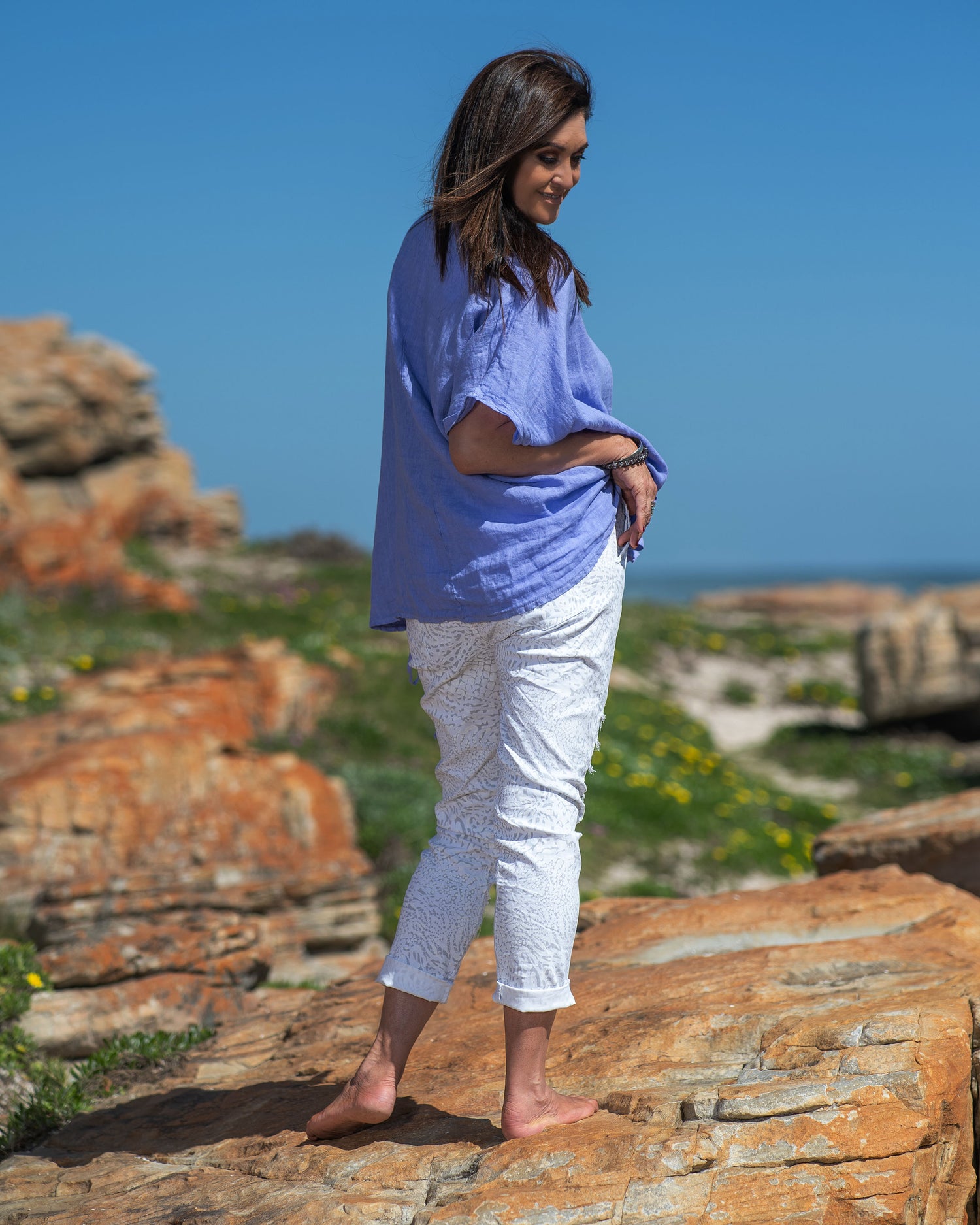 Step into the world of casual chic with this very comfortable, yet stylish linen top. What sets this top apart is its playful frill detailing, adding a touch of whimsy and femininity to your look. The natural, breathable linen fabric keeps you cool and fresh even on the warmest days, making it a must-have addition to your summer wardrobe