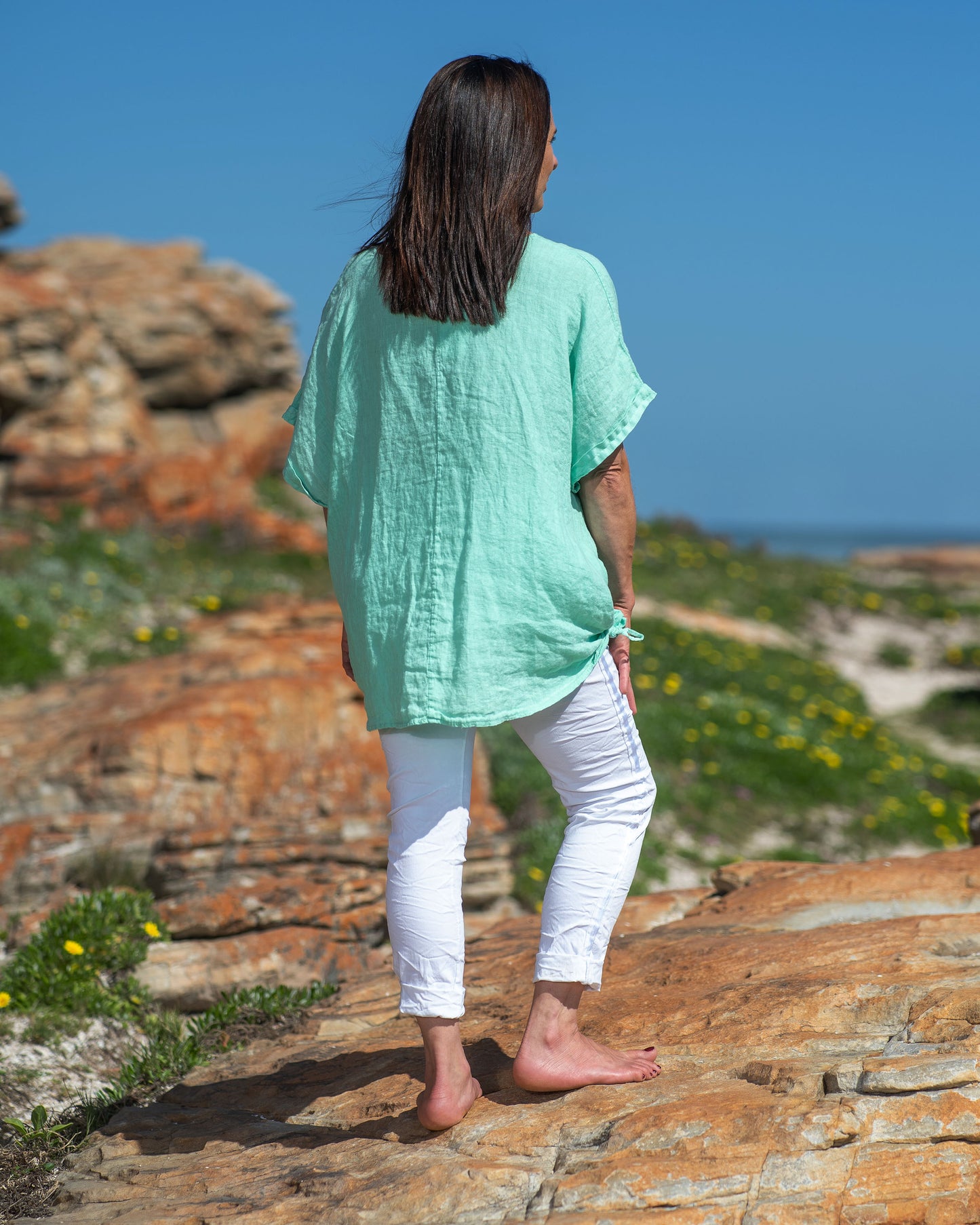 Step into the world of casual chic with this very comfortable, yet stylish linen top. What sets this top apart is its playful frill detailing, adding a touch of whimsy and femininity to your look. The natural, breathable linen fabric keeps you cool and fresh even on the warmest days, making it a must-have addition to your summer wardrobe