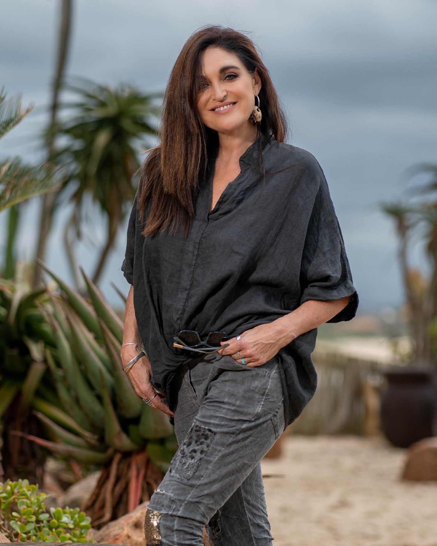 The subtle twist detail not only enhances the visual appeal but also provides a flattering fit, accentuating your waistline and creating a feminine, flowing effect. The batwing sleeves drape gracefully, creating a sense of airiness and movement. Whether you're heading to brunch, a beachside gathering, or a casual day out, this top effortlessly elevates your style