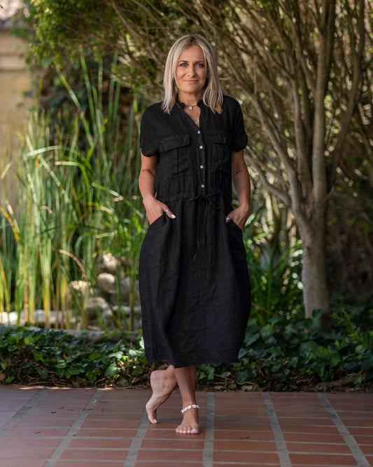 Perfect for any occasion, this short sleeve linen dress effortlessly transitions from day to night. Drawstring waistband, allowing you to cinch it in for a more tailored silhouette or leave it loose for a relaxed fit. In addition to the double breast pockets, this dress features convenient side pockets, offering extra versatility and practicality